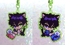 Load image into Gallery viewer, Anime character chibi keychain with purple hair in green border with soccer ball.